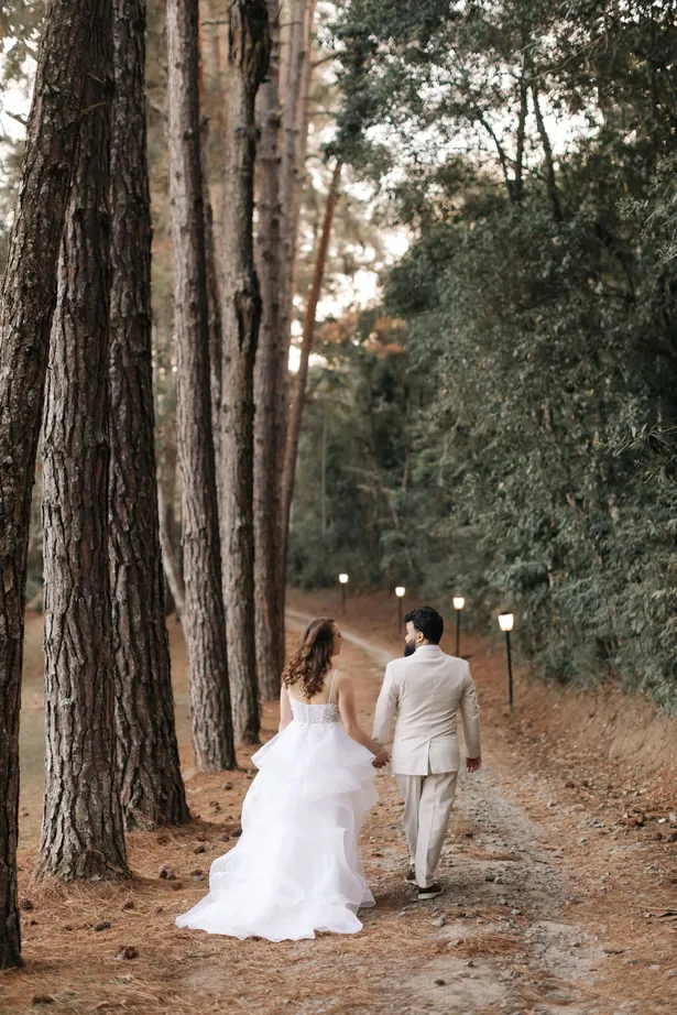 Casal caminhando entre pinheiros